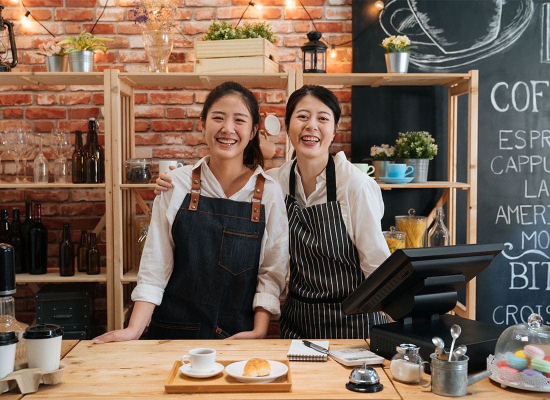 Business Insurance - Portrait of a Cheerful Asian Mother and Daughter Standing by the Front Counter Inside Their Small Cafe Shop.psd